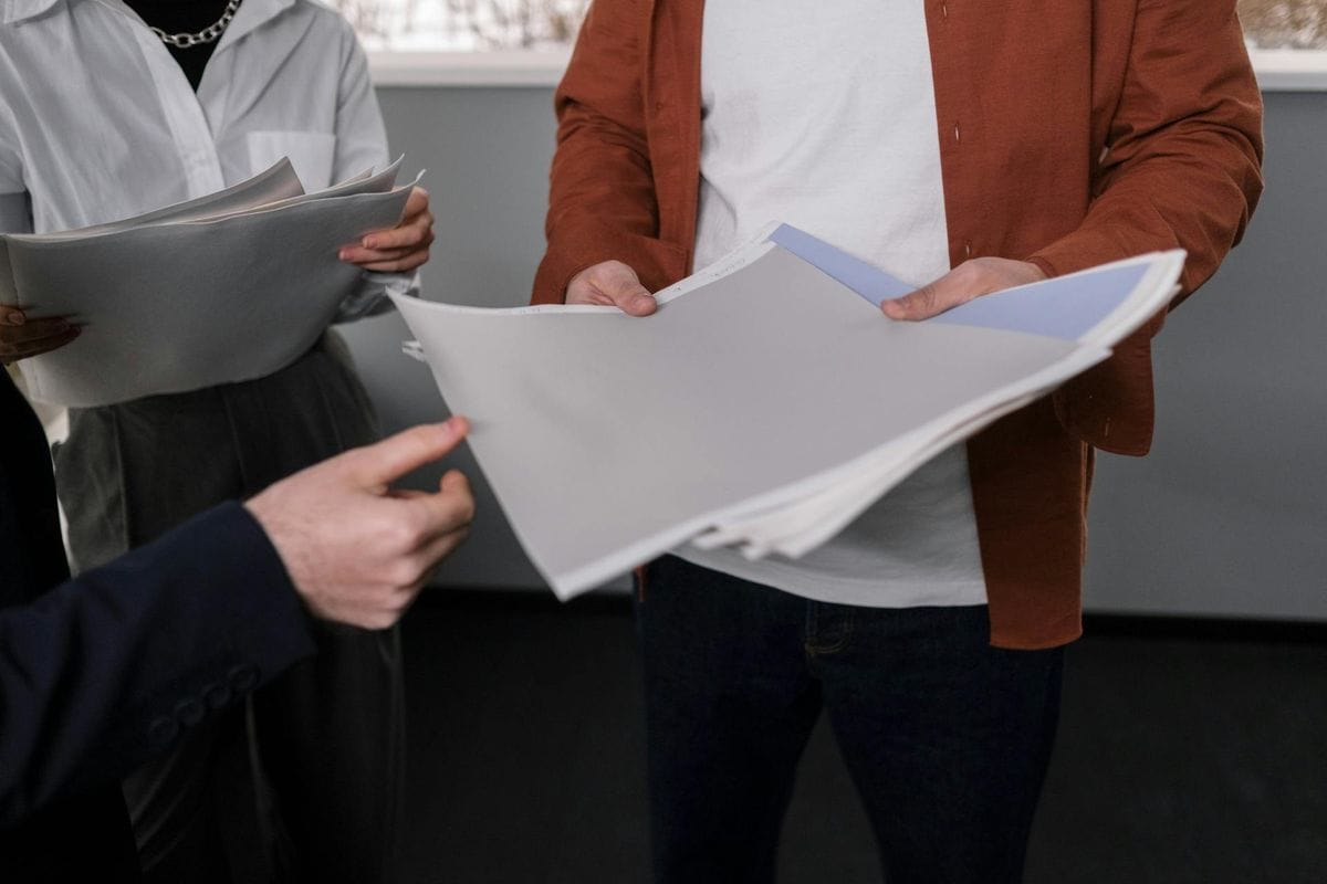 Business professionals discussing interior design samples during a project meeting.