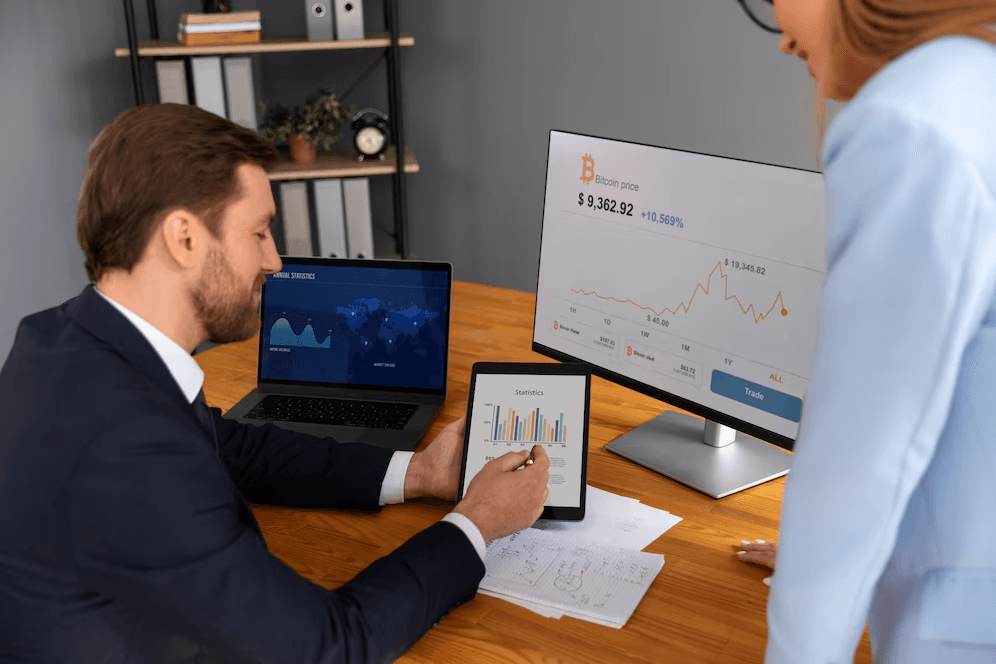 Employees looking over sales graph.