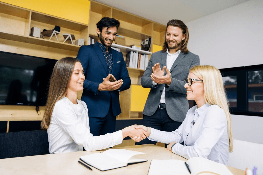 Businesswomen handshaking after deal agreement