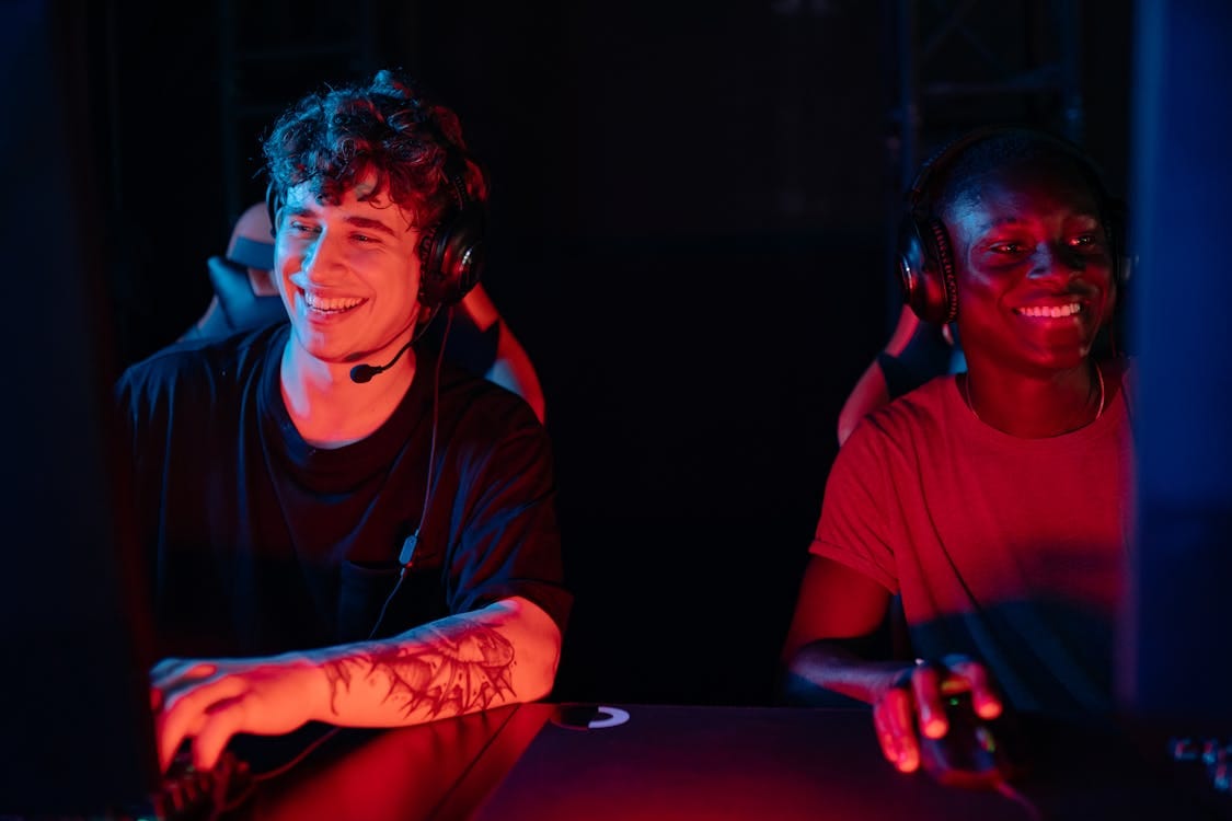 Male enjoying PC gameplay with headsets — concept of engaging, fast-paced video content.