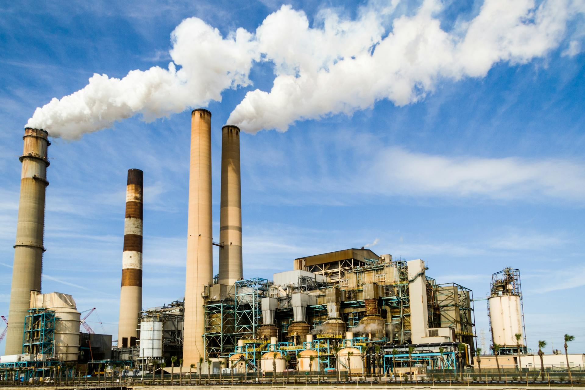Photo by Pixabay: https://www.pexels.com/photo/photo-of-an-industrial-factory-emitting-smoke-247763/ for a blog on generative ai use cases in manufacturing