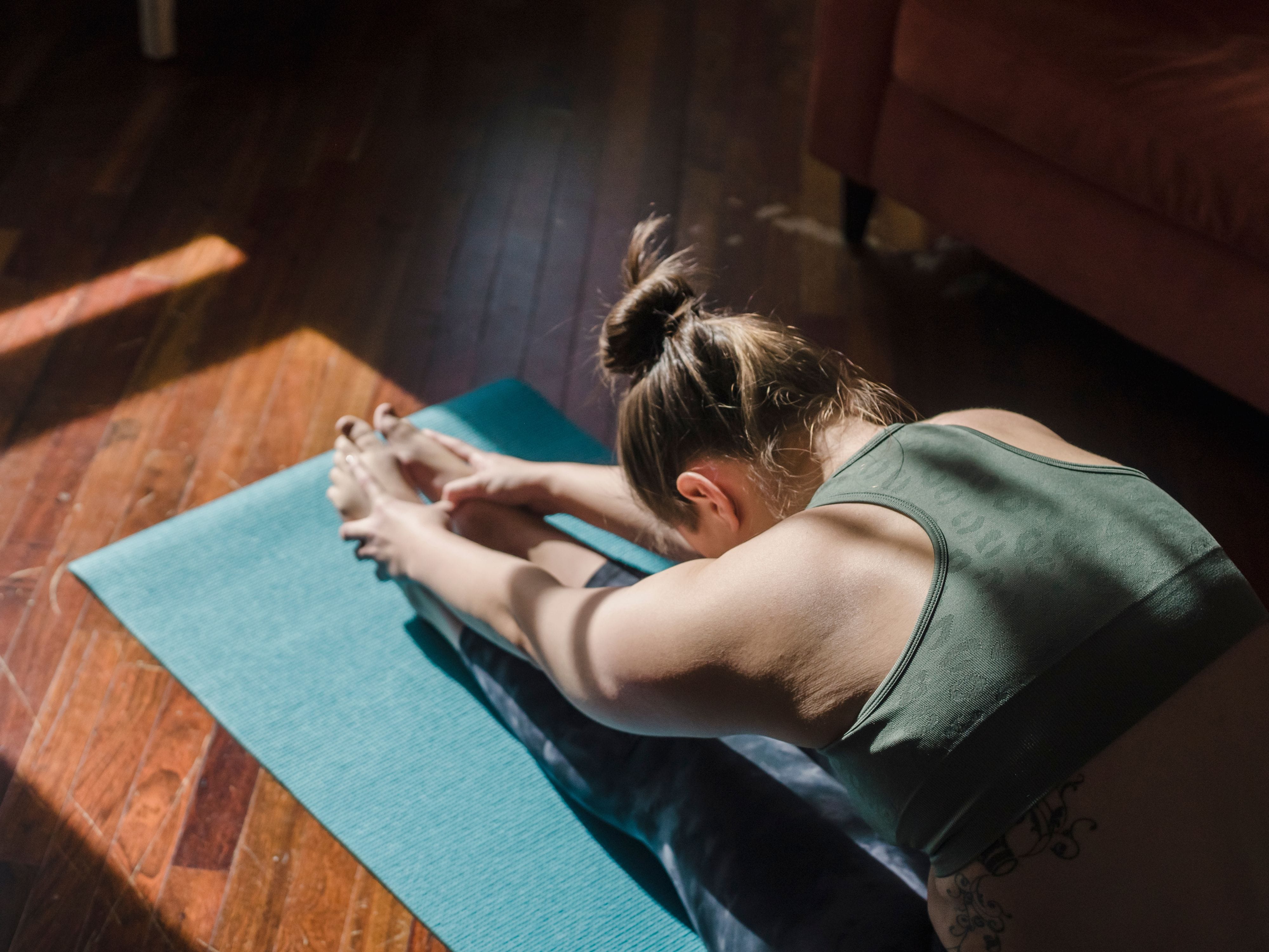 Woman practicing yoga on her mat