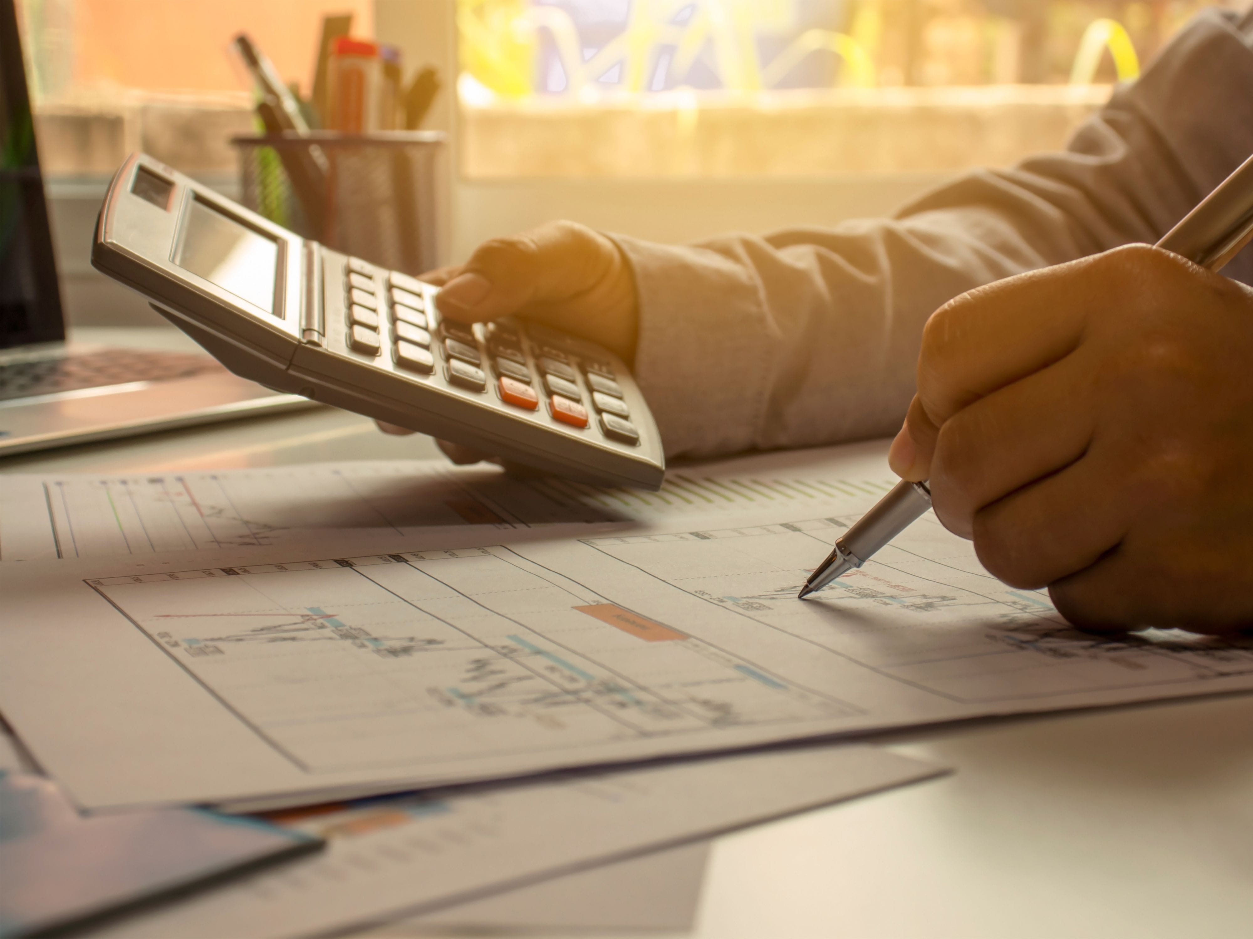 Person calculating expenses – understanding investment philosophy