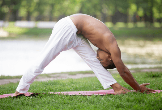 Man doing intense side stretch yoga for flexibility outdoors