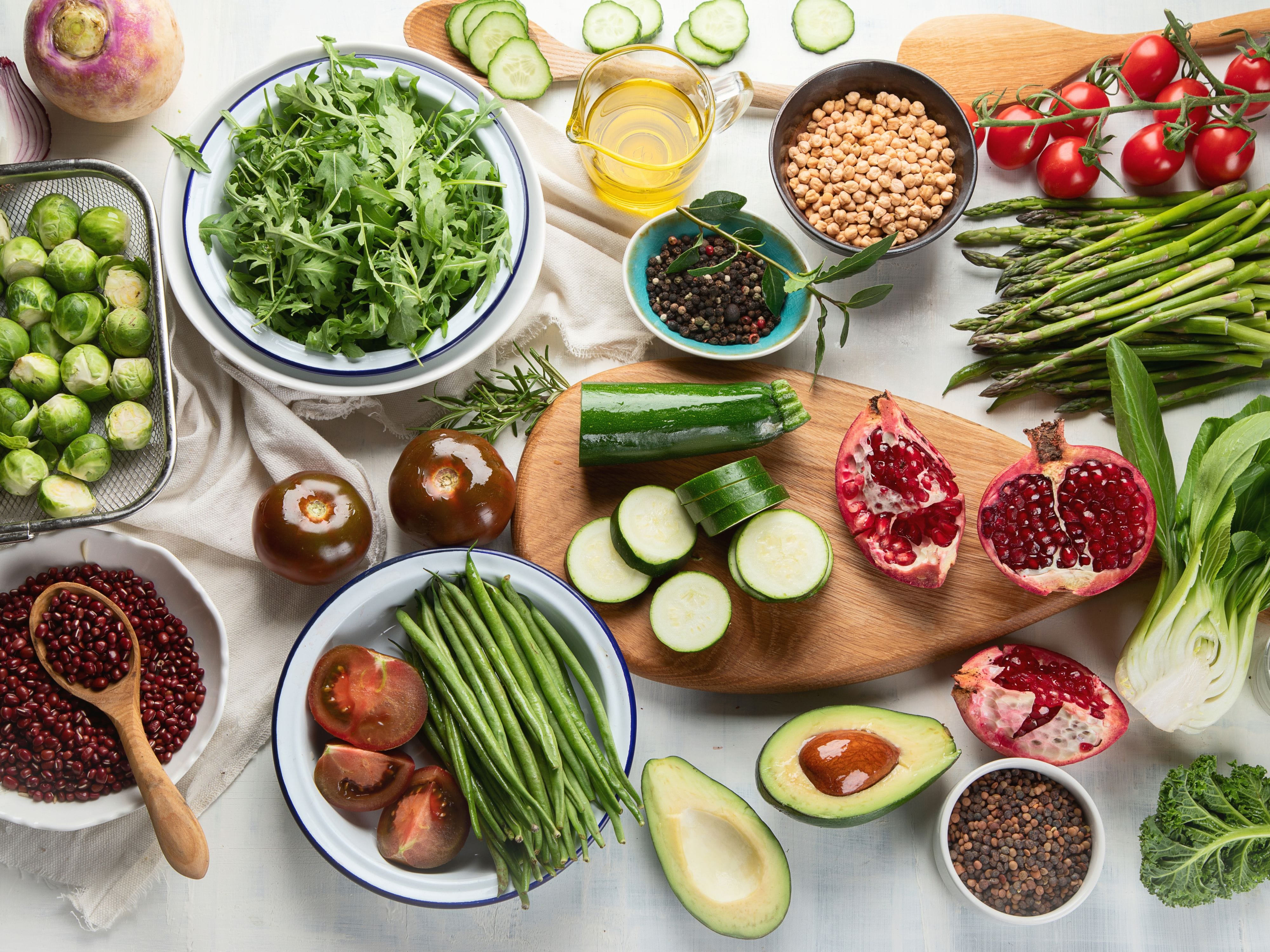 Neatly organized fruits and vegetables in bowls and glass containers