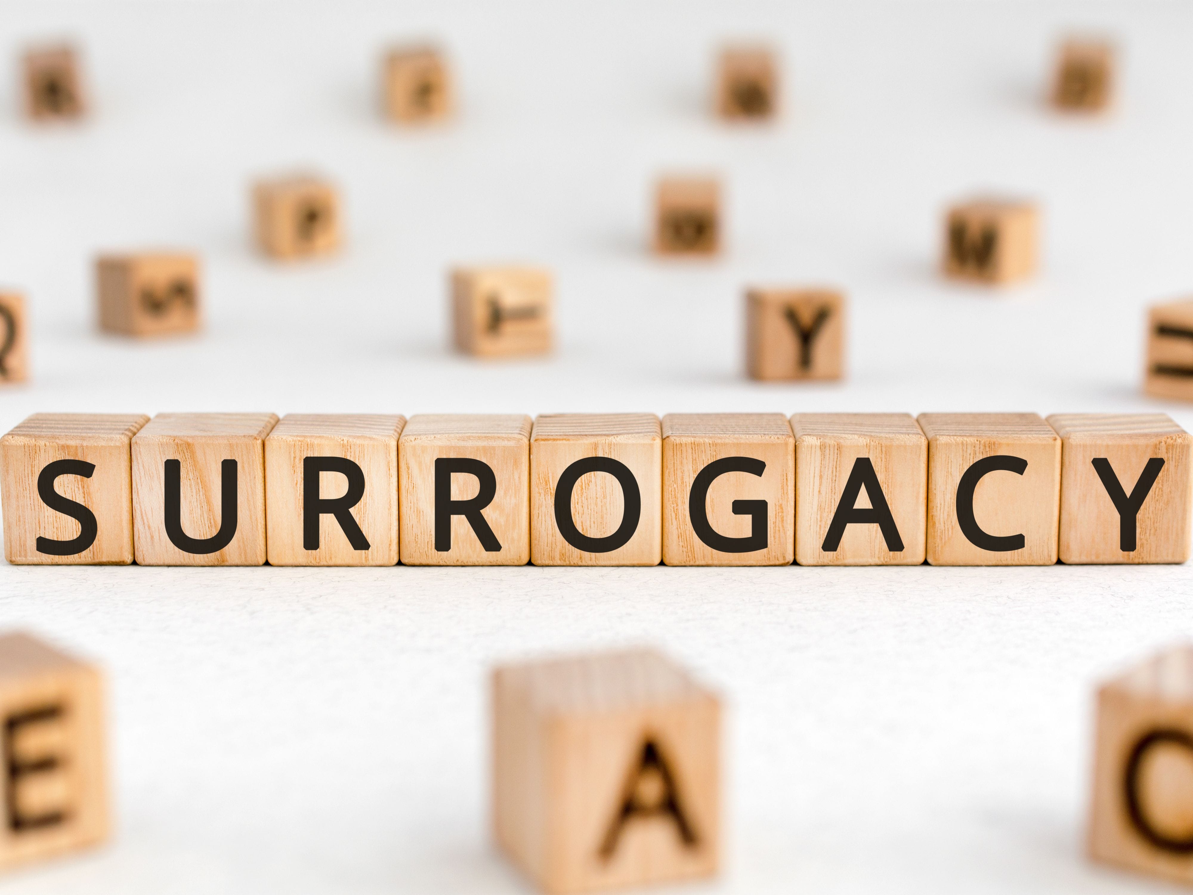 Wooden blocks spelling "SURROGACY"