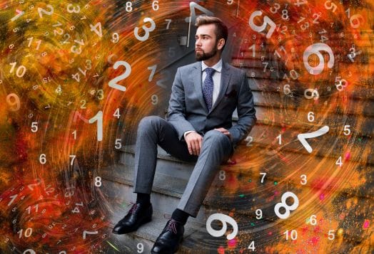 Man in a suit surrounded by numerology numbers