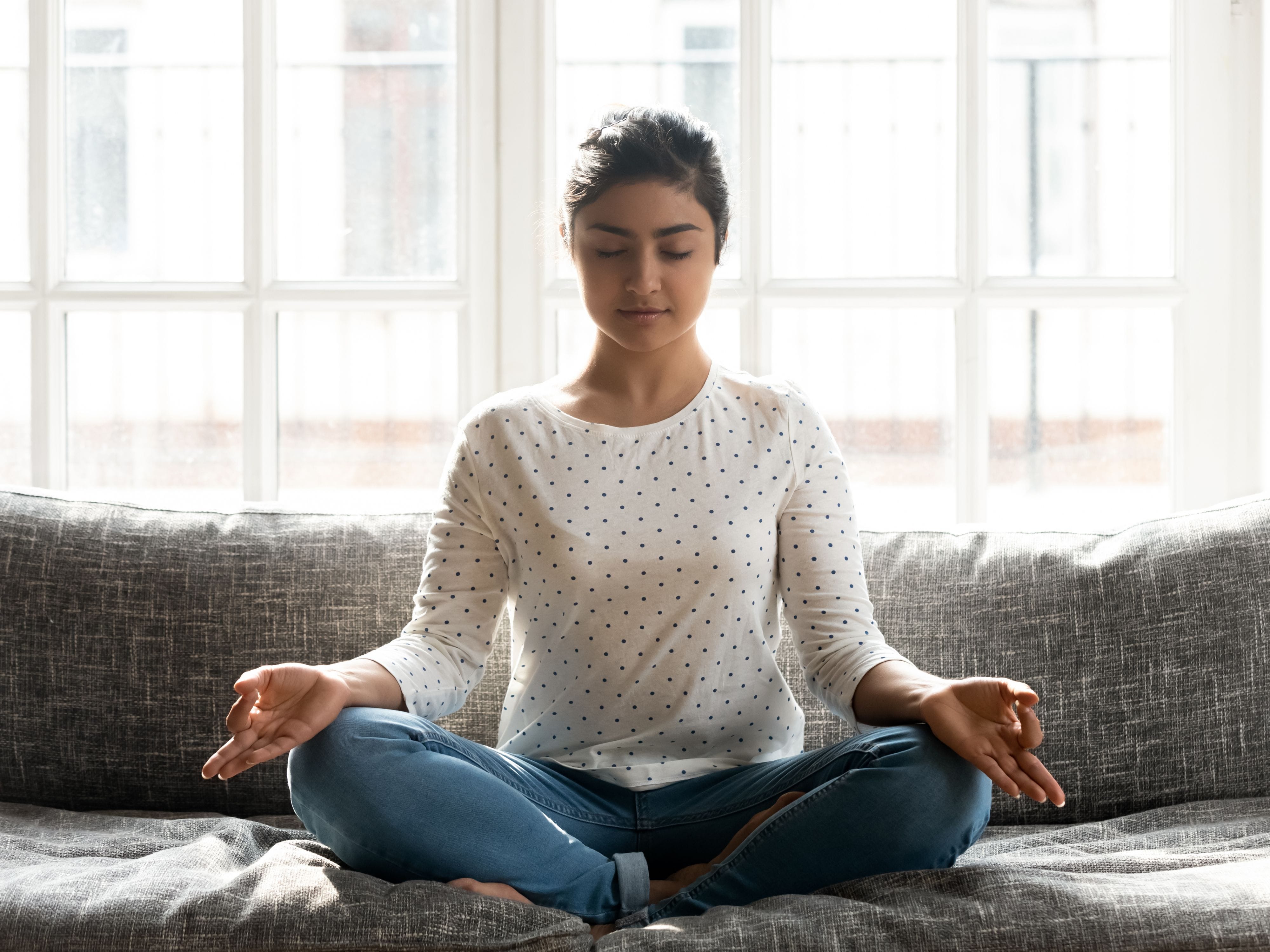 Person practicing pranayama breathing techniques for relaxation and well-being