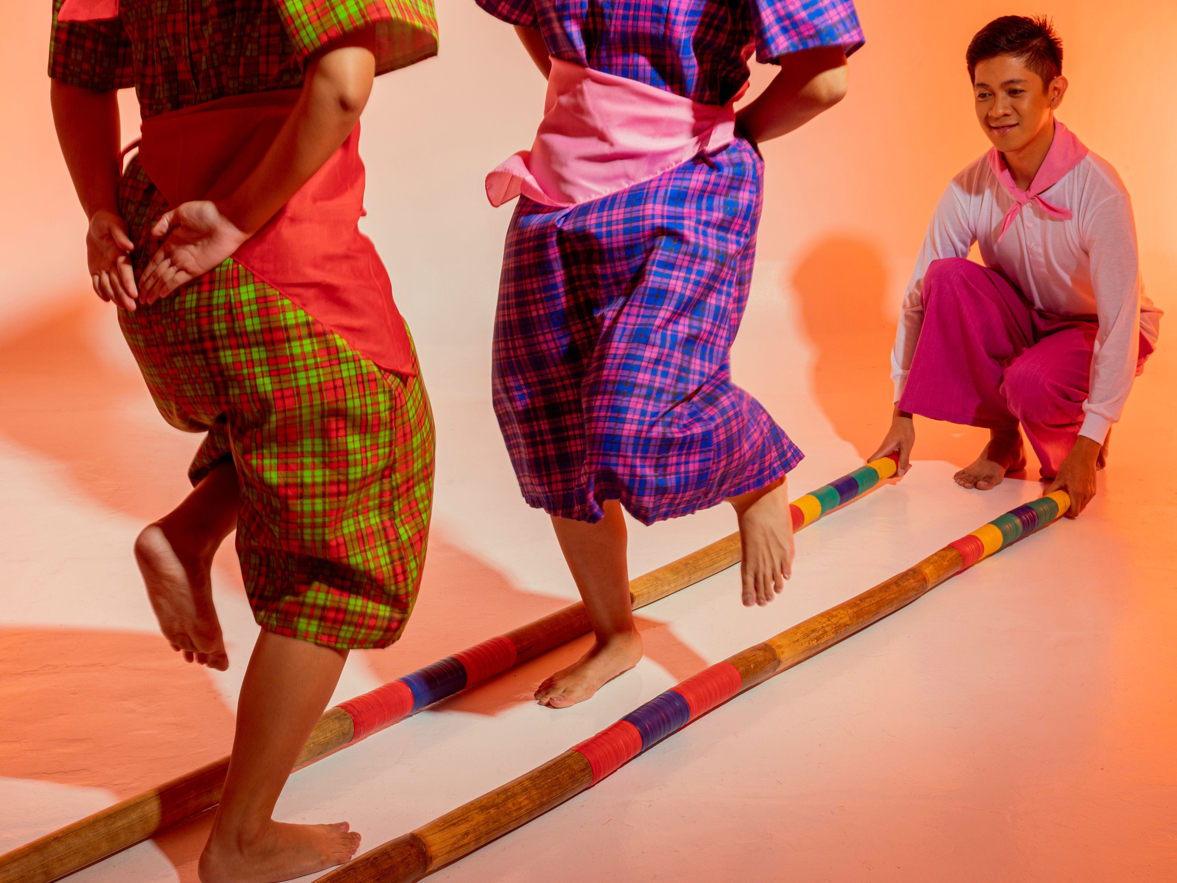 Two women doing Nepal’s stick folk dance