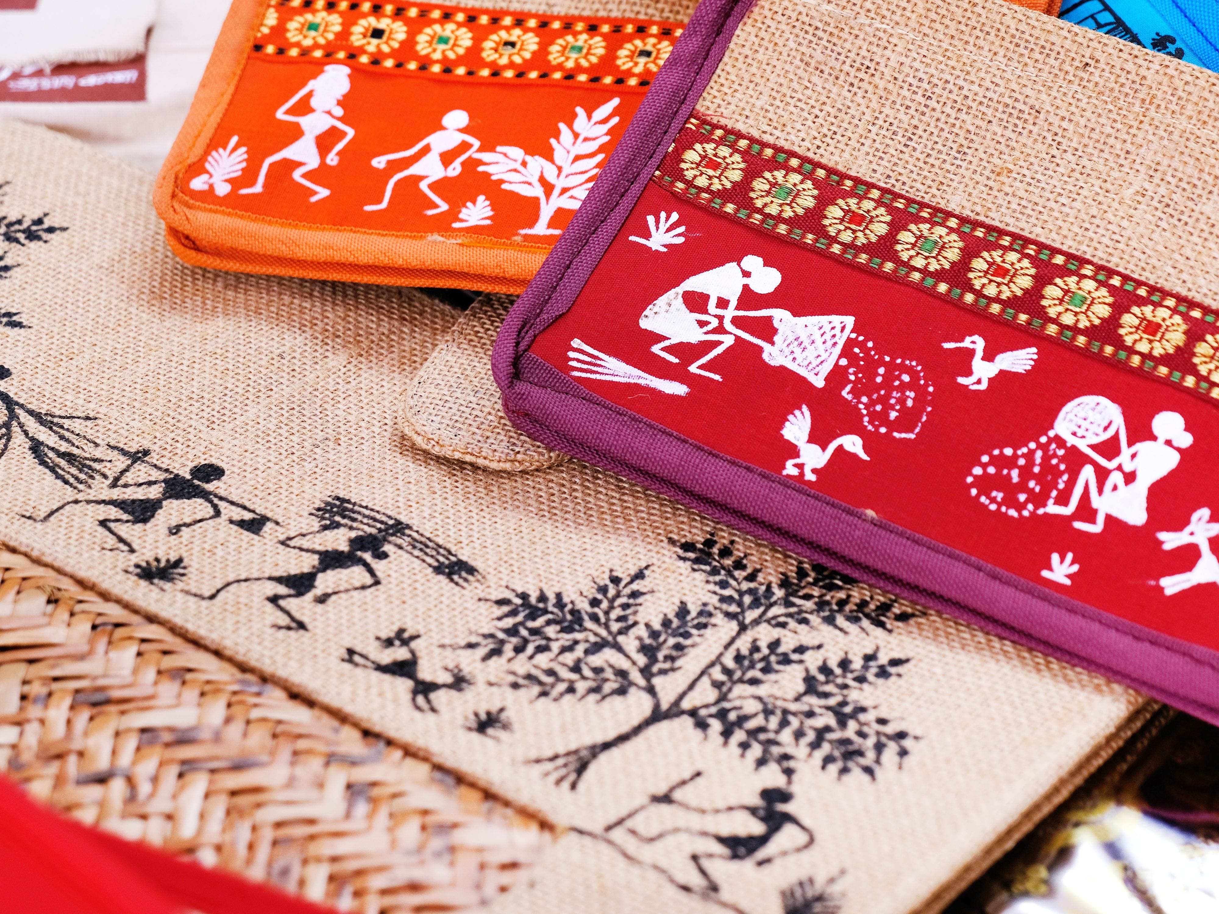 Warli paintings on fabric pouches