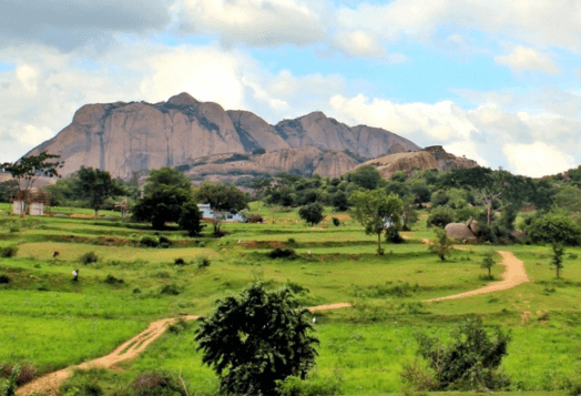 Savandurga: green fields, dirt roads, rocky monolith