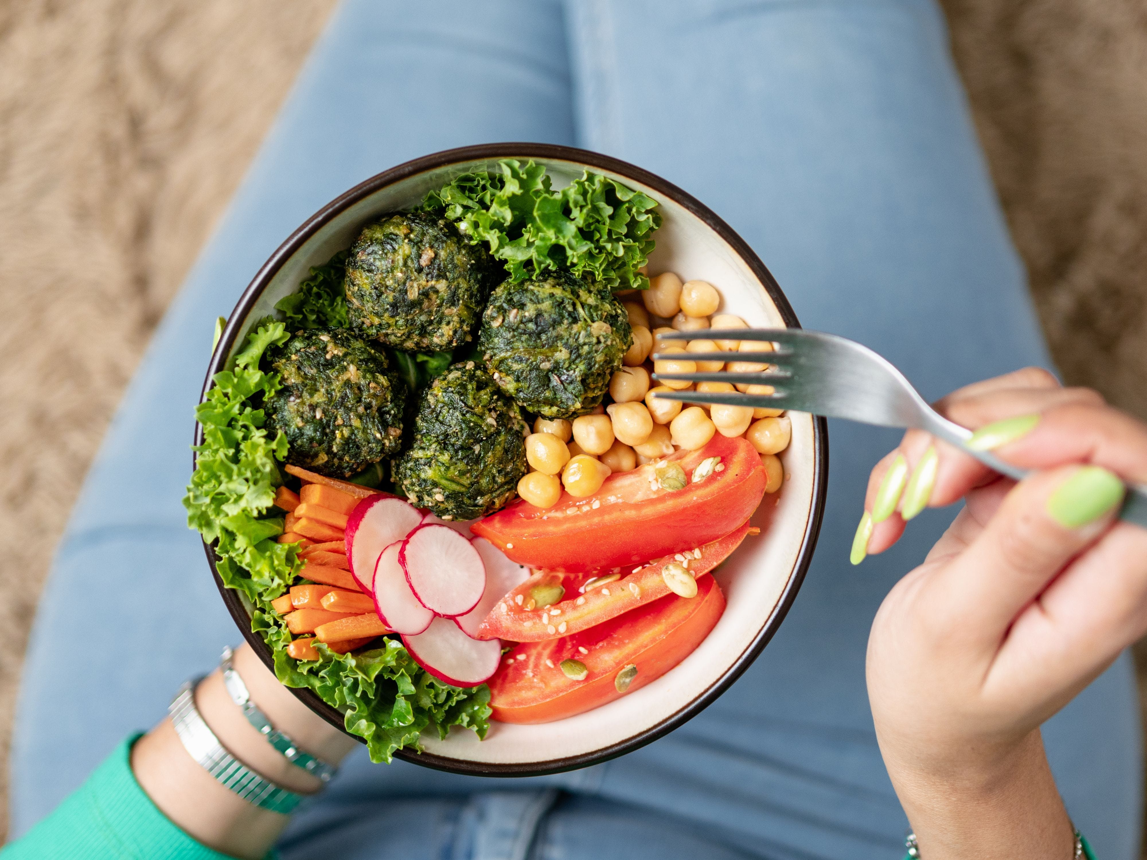 Person eating healthy salad bowl