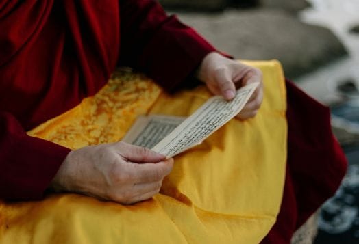 Monk reading a script