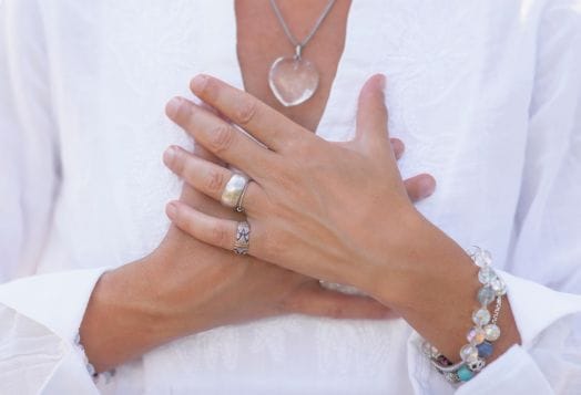 Woman holding her hands over heart