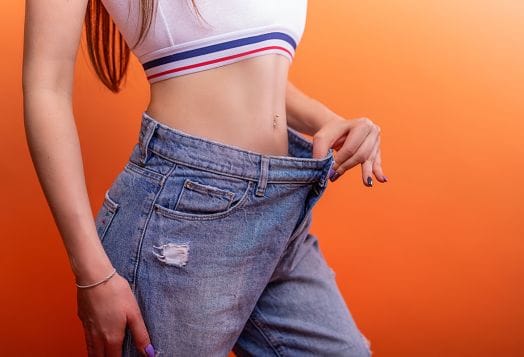 Woman in loose jeans after weight loss
