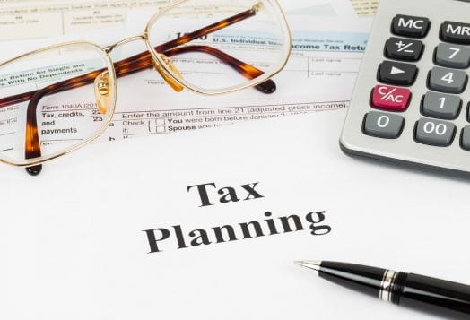 Tax planning documents with glasses and calculator