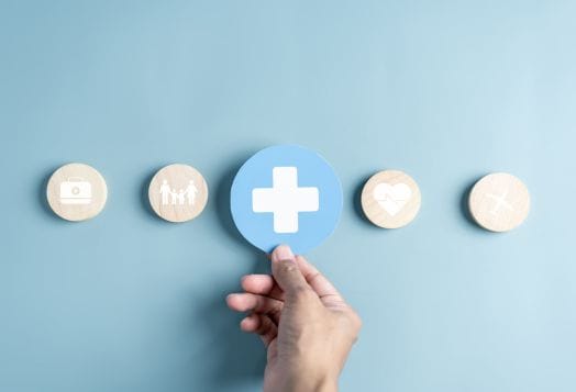 Hand selecting a health insurance icon