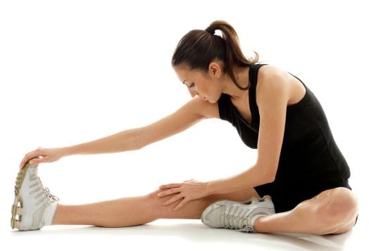Woman in sportswear stretching her leg