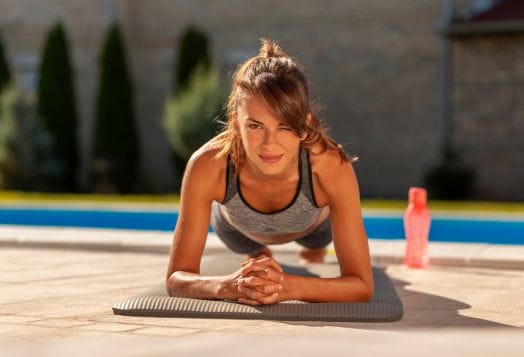 Woman doing a forearm plank outdoors