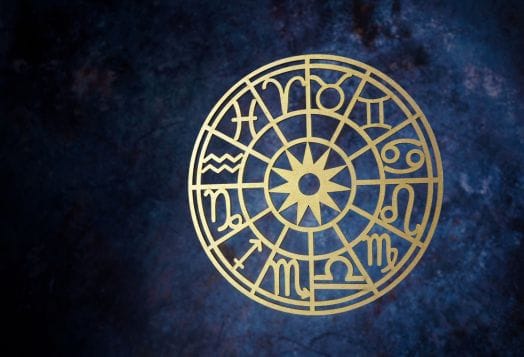 Golden zodiac wheel on a cosmic background