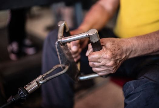 Close-up of senior man's hands on a seated cable row machine