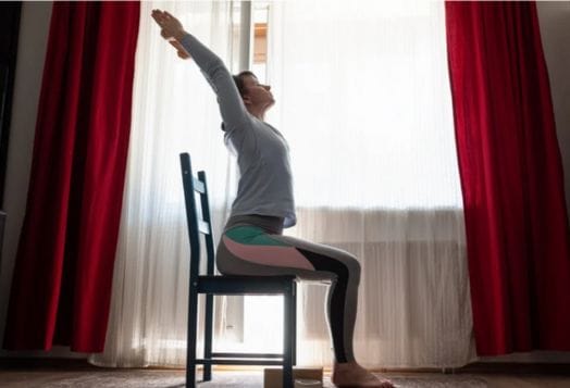 Woman doing a seated upward stretch