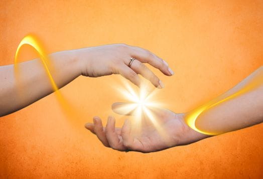 Two hands exchanging energy