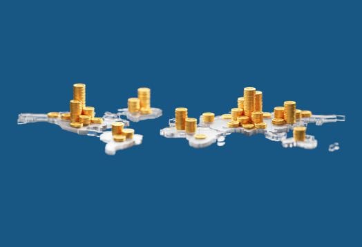 Stacks of gold coins on a world map