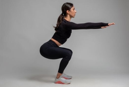 A woman performing a squat exercise
