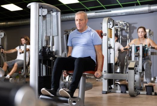Man using a leg extension machine at the gym