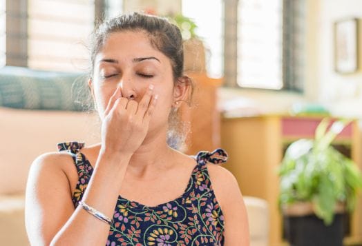 Woman doing alternate nostril breathing