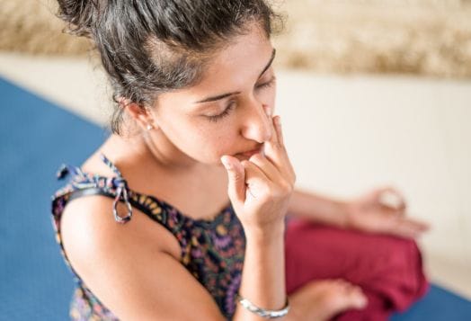 Woman doing alternate nostril breathing