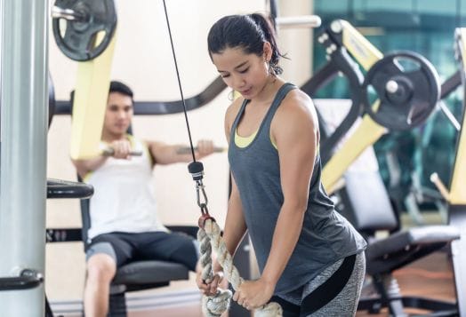 Woman doing tricep pushdowns