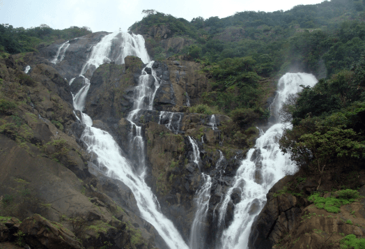 The majestic Dudhsagar Falls, a multi-tiered waterfall cascading down a lush green mountain