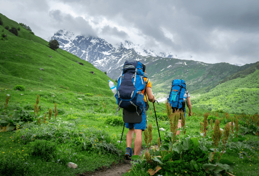 Two hikers with backpacks on a mountain trail