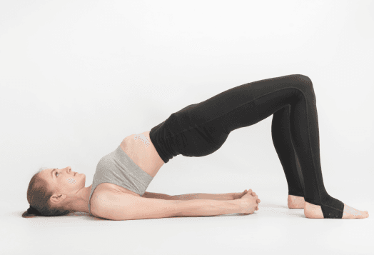 A woman practicing Bridge Pose (Setu Bandhasana)