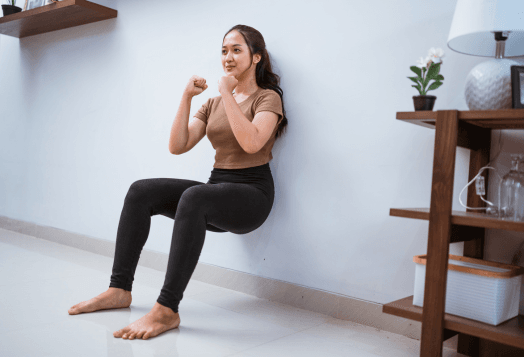 A woman practices Wall Sit Meditation