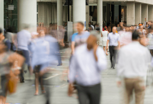 A blurry image of a busy street with people walking, suggesting motion