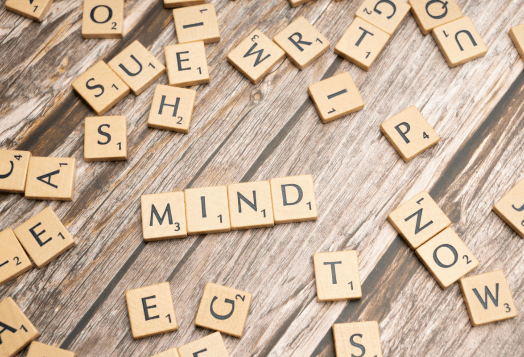 Scrabble tiles spelling out the word 'MIND'