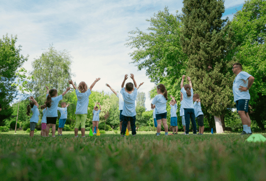 Kids and adults exercising outdoors in a park