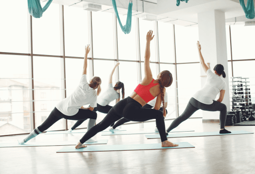 Women in a yoga class doing warrior poses