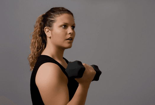 Woman in black top doing bicep curls with a dumbbell