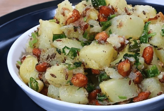 A close-up of a bowl of Aloo Ki Sabzi, with cumin and peanuts