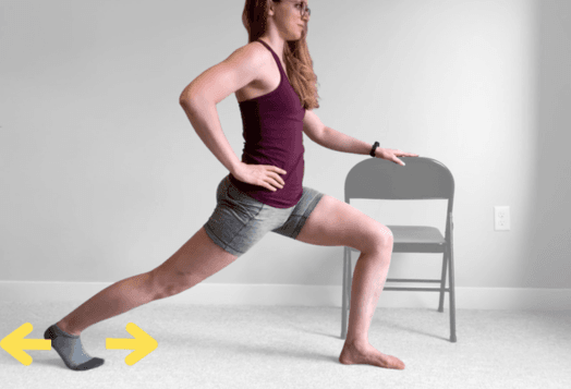 A woman in a maroon tank top and shorts doing a lunge, holding onto a metal folding chair for support. Yellow arrows point to her back foot, indicating the direction of movement