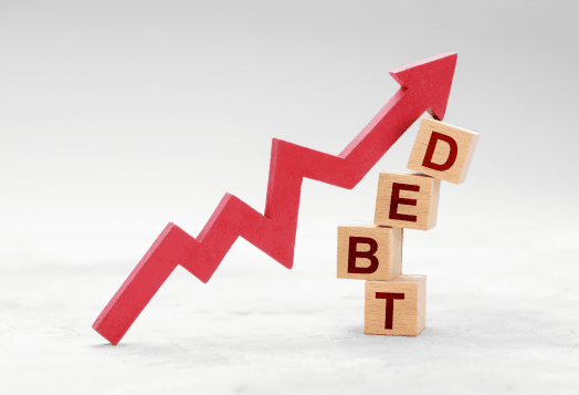Red arrow rising upward supported by wooden blocks spelling debt