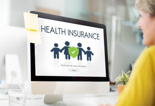 Woman looking at a "Health Insurance" webpage