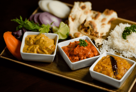 Indian thali with curries, naan, and rice