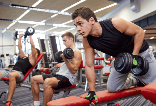 Men lifting dumbbells in a gym
