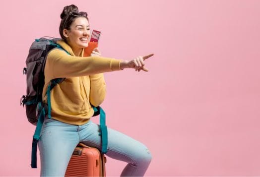 Happy traveler pointing with passport