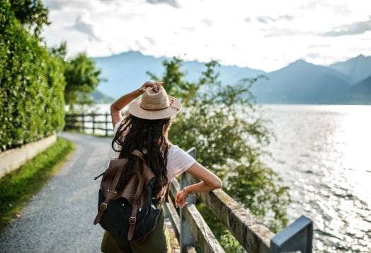 Woman with backpack looking at a lake